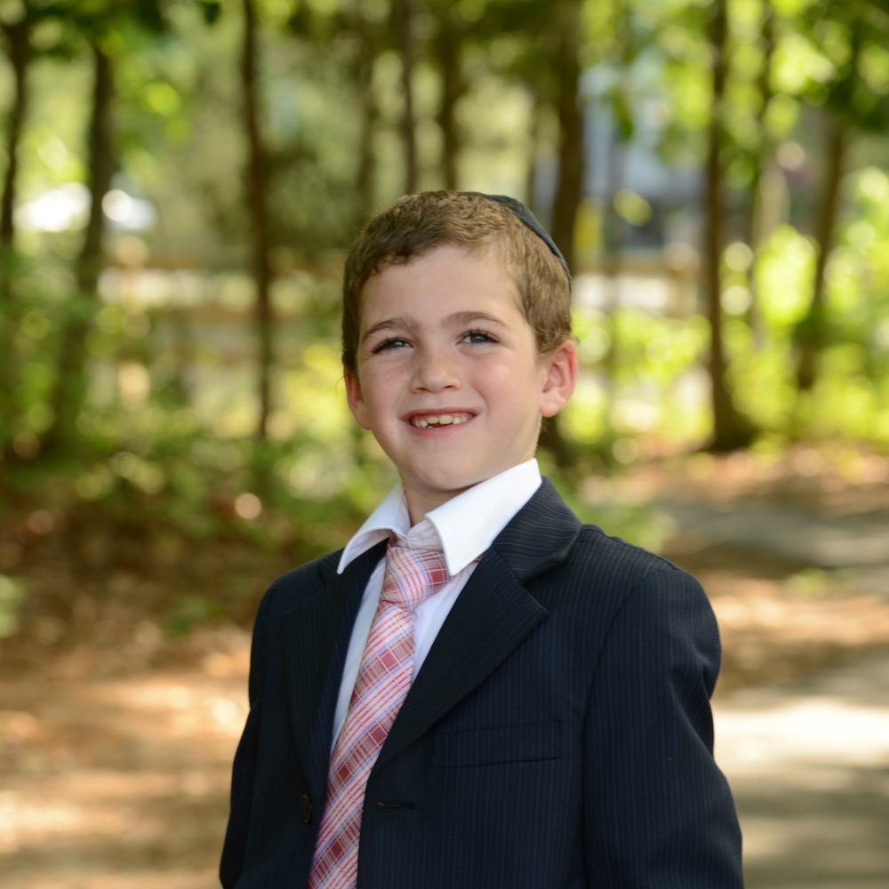 Shloimy outdoors in a suit